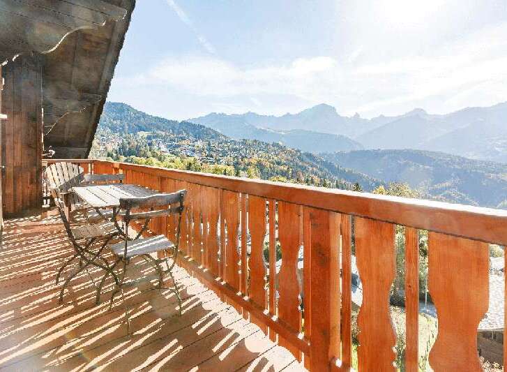 Enjoy breathtaking mountain views from this charming balcony.