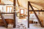 Discover the charm of this cozy attic retreat, featuring exposed wooden beams and a warm, inviting atmosphere.
