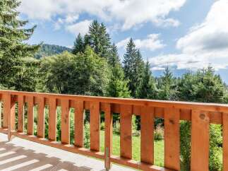 Enjoy breathtaking mountain views from this charming balcony.