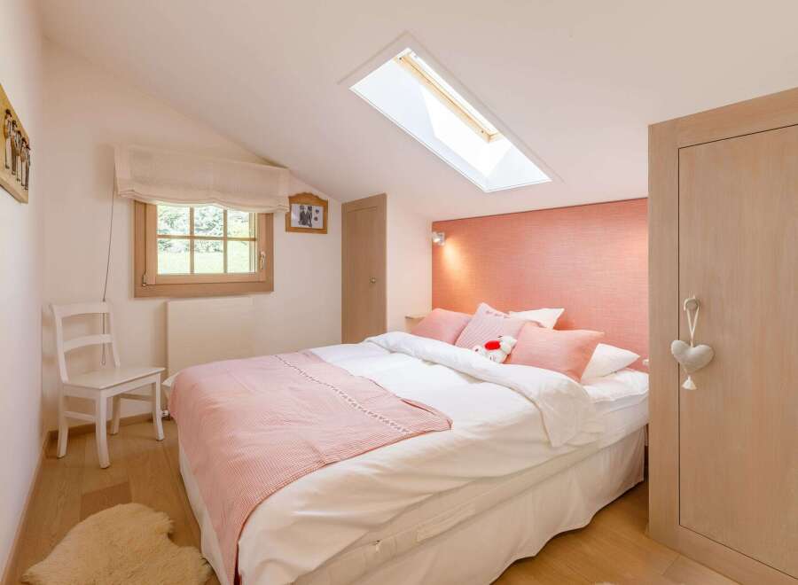 This cozy bedroom features a charming design with a touch of elegance.