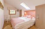 This cozy bedroom features a charming design with a touch of elegance.