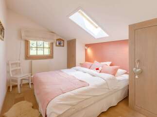 This cozy bedroom features a charming design with a touch of elegance.