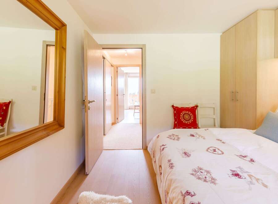This cozy bedroom features a comfortable bed with a decorative comforter and pillows.