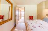 This cozy bedroom features a comfortable bed with a decorative comforter and pillows.