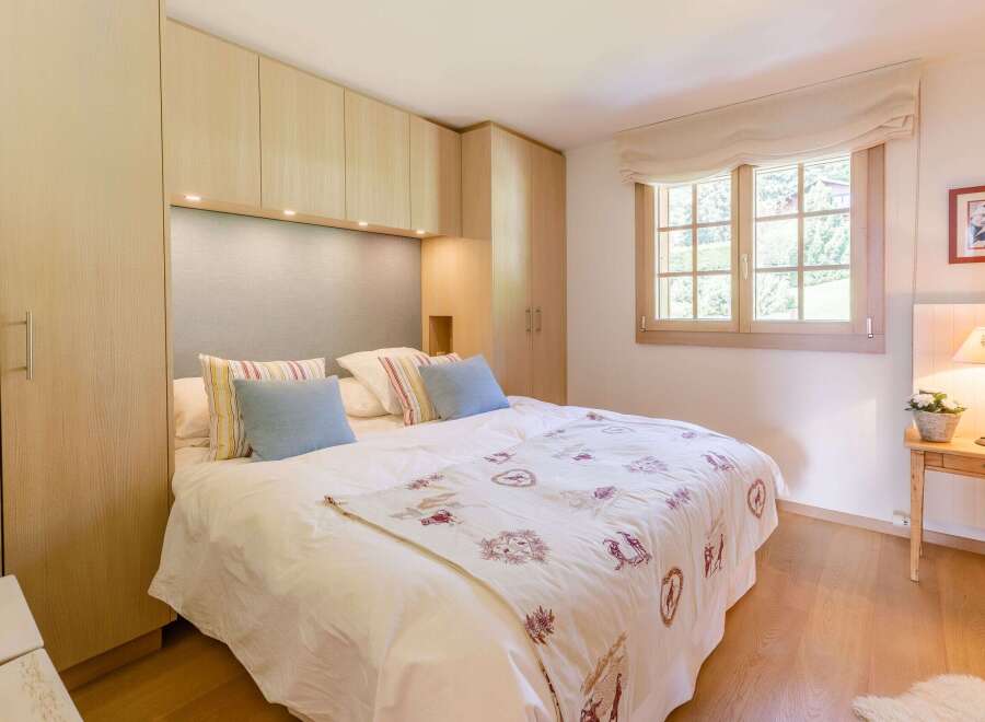 Cozy bedroom with a comfortable bed and stylish decor.