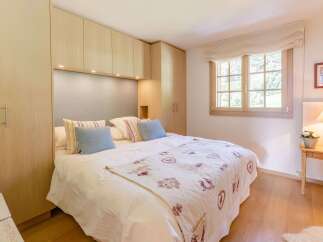 Cozy bedroom with a comfortable bed and stylish decor.