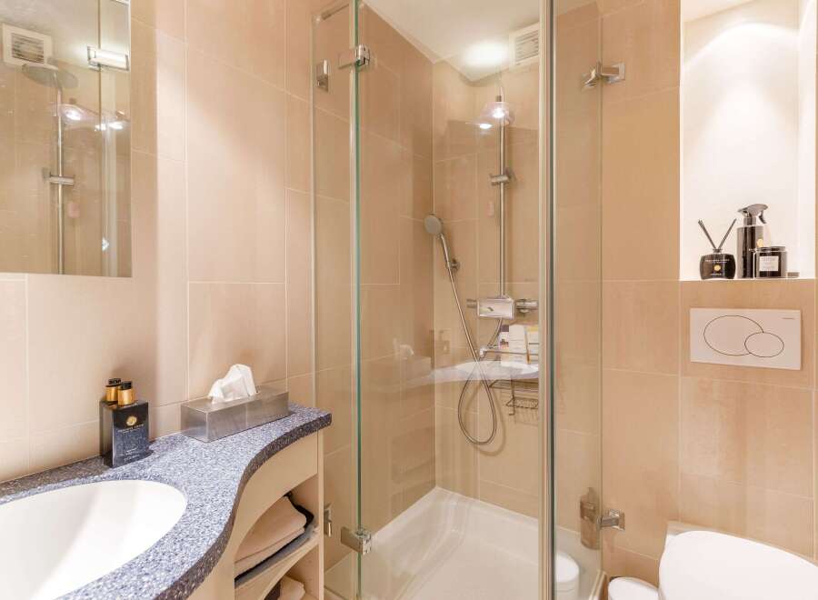 This modern bathroom features a sleek glass shower enclosure, offering a spa-like experience.