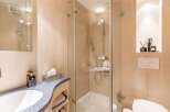 This modern bathroom features a sleek glass shower enclosure, offering a spa-like experience.