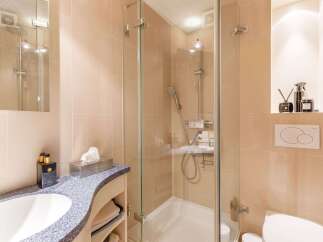 This modern bathroom features a sleek glass shower enclosure, offering a spa-like experience.