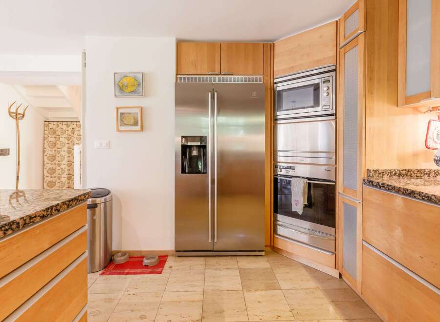 This stunning kitchen boasts modern appliances and custom cabinetry.