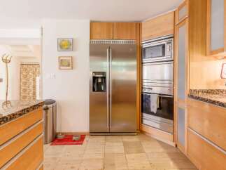 This stunning kitchen boasts modern appliances and custom cabinetry.