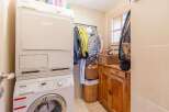 This cozy laundry room features a modern Miele washer and dryer set, perfect for efficient laundry days.