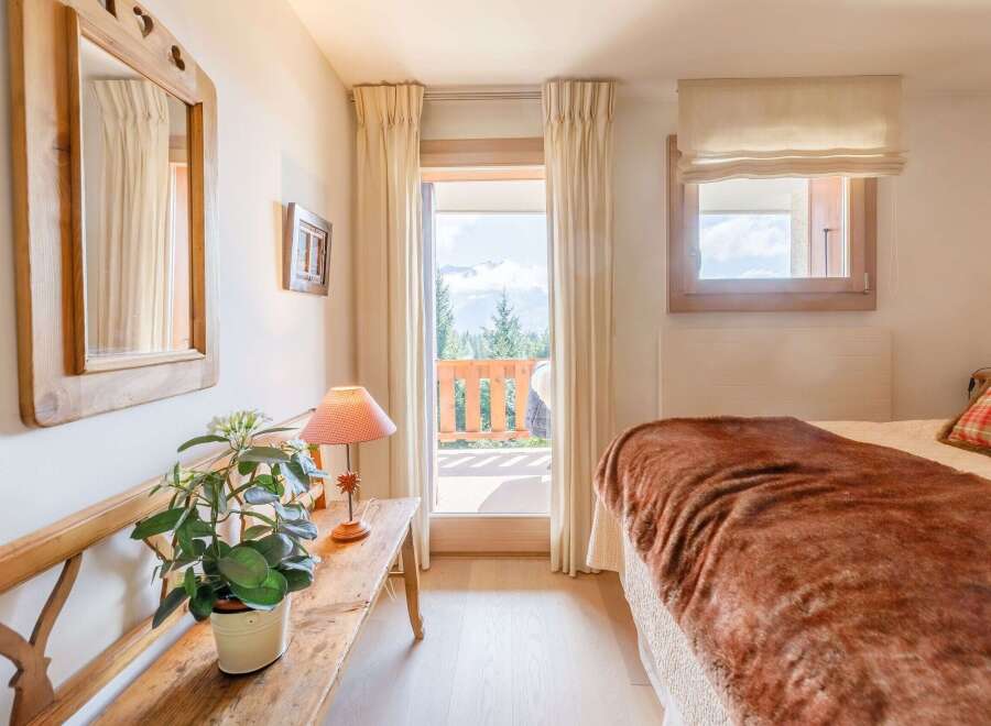 Cozy bedroom with a stunning mountain view.