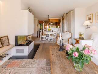 This stunning property boasts a modern fireplace, creating a cozy ambiance.
