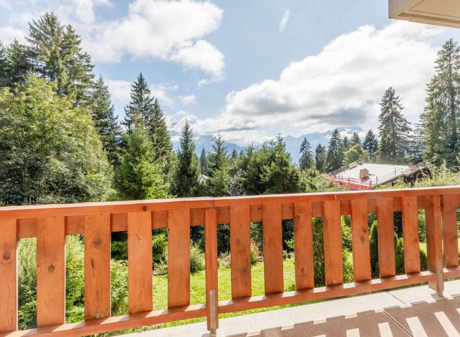 Enjoy breathtaking mountain views from this charming balcony.