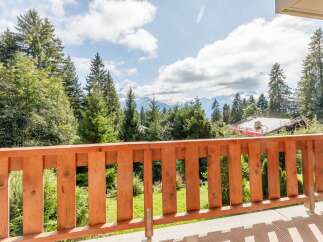 Enjoy breathtaking mountain views from this charming balcony.