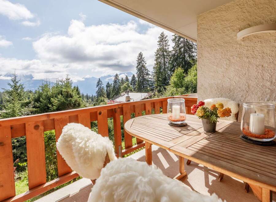 Enjoy breathtaking mountain views from this charming balcony.