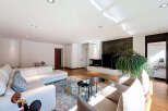 Stunning living room with a modern fireplace and large windows, offering ample natural light.