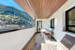 This stunning balcony boasts breathtaking mountain views and a spacious layout perfect for outdoor dining and relaxation.