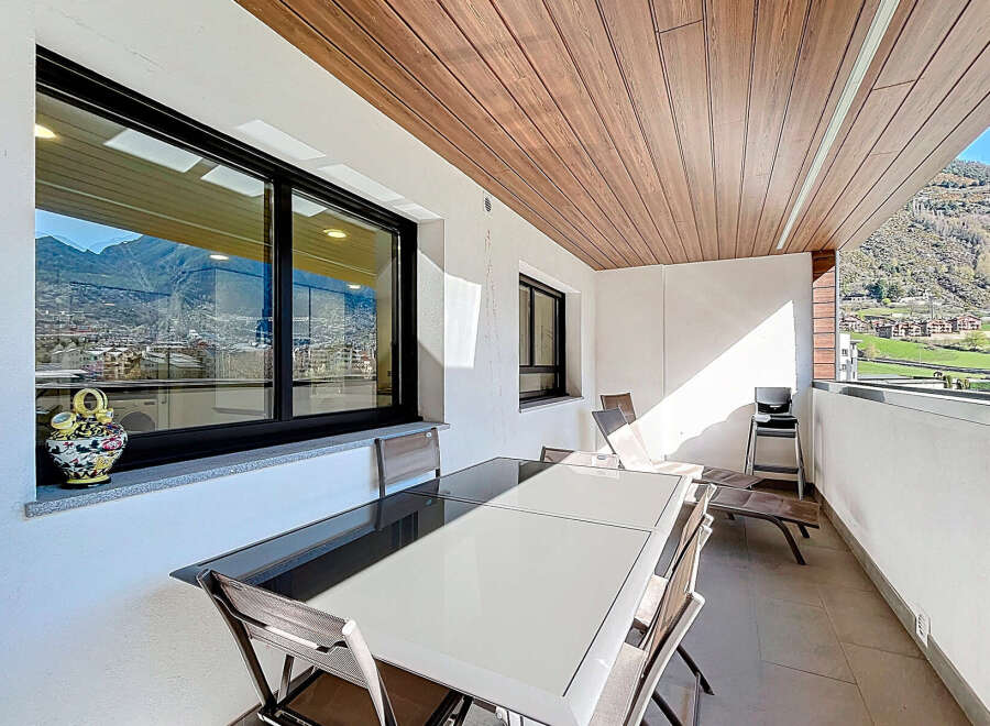 Enjoy outdoor dining with mountain views on this spacious balcony.
