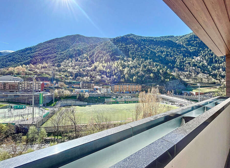 Breathtaking mountain views from this modern apartment's balcony.