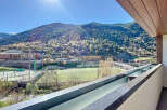Breathtaking mountain views from this modern apartment's balcony.