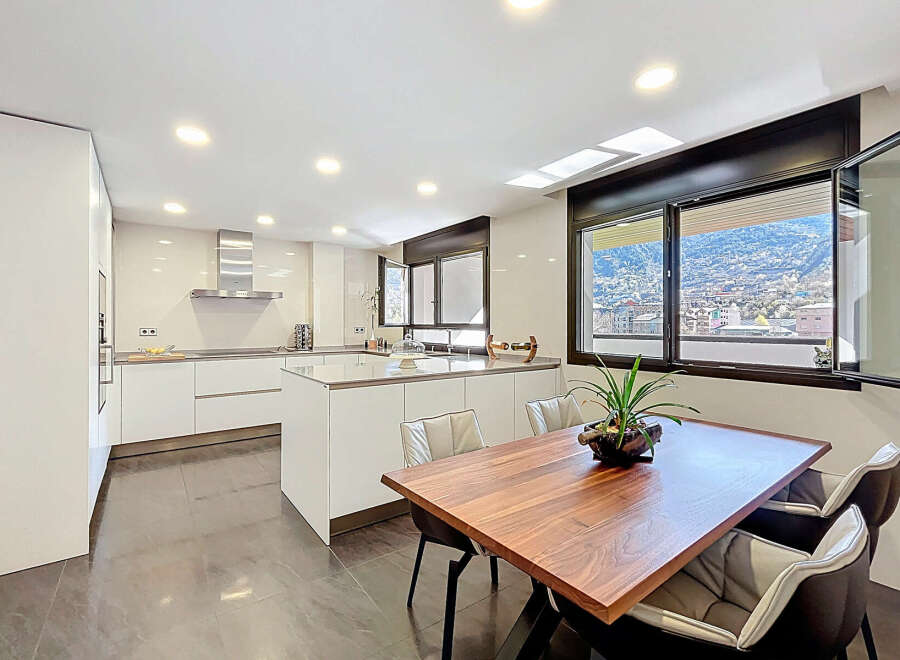 Modern kitchen with sleek white cabinetry and a large island, perfect for entertaining.