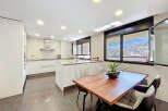 Modern kitchen with sleek white cabinetry and a large island, perfect for entertaining.