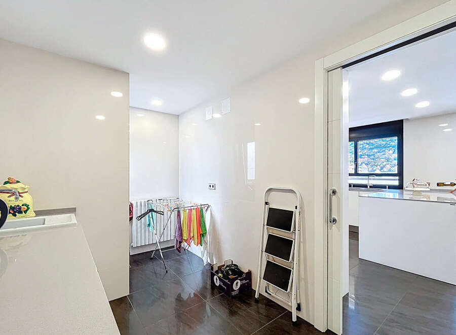 This stunning property boasts a bright and airy laundry room, complete with modern appliances and ample storage.