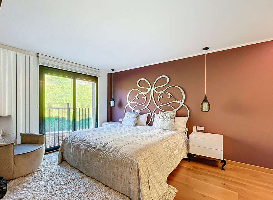 Luxurious bedroom with a king-size bed and an ornate headboard.