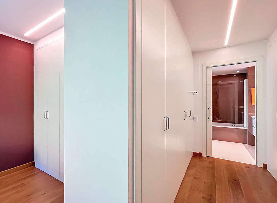 This stunning property boasts a spacious hallway with built-in wardrobes, offering ample storage space.