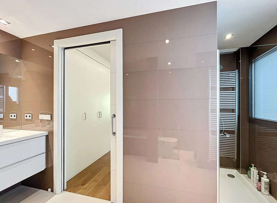 This stunning bathroom boasts a modern design with sleek, neutral tones and high-end finishes.