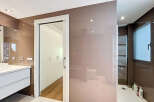 This stunning bathroom boasts a modern design with sleek, neutral tones and high-end finishes.