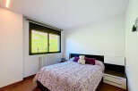 Cozy bedroom with a double bed, featuring a beautiful patterned duvet and plush pillows.