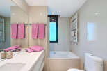 This stunning bathroom boasts modern fixtures and a clean, minimalist design.