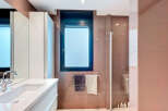 Modern bathroom with sleek white vanity and integrated sink.