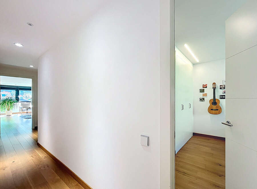 This stunning property boasts a bright and spacious hallway with gleaming hardwood floors.