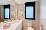 Modern bathroom with white countertops and a sleek design.