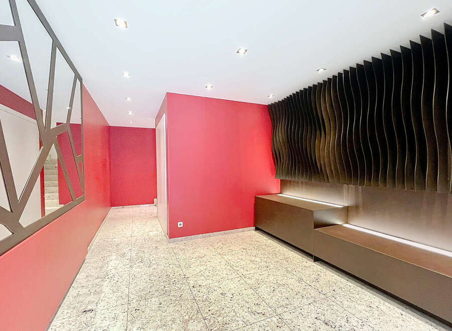 This stunning property boasts a modern and stylish hallway with unique design features.