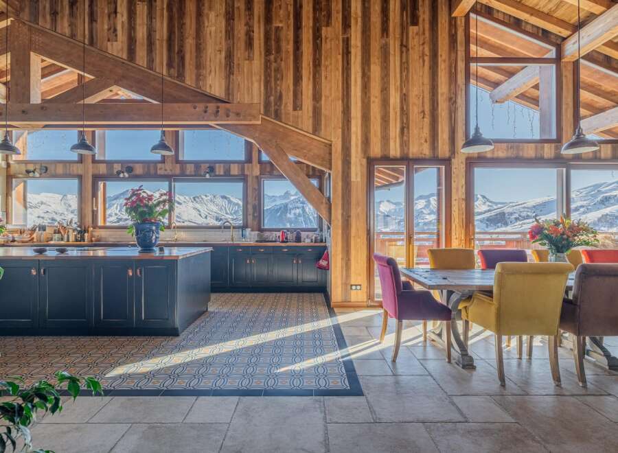 This stunning chalet boasts a spacious open-plan kitchen and dining area with breathtaking mountain views.