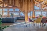 This stunning chalet boasts a spacious open-plan kitchen and dining area with breathtaking mountain views.
