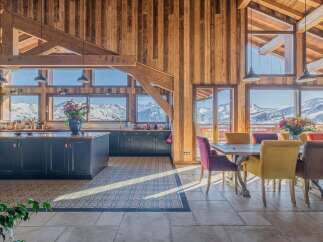 This stunning chalet boasts a spacious open-plan kitchen and dining area with breathtaking mountain views.