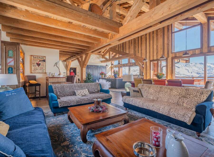 Luxurious chalet with stunning mountain views and exposed wooden beams.