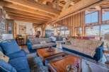 Luxurious chalet with stunning mountain views and exposed wooden beams.