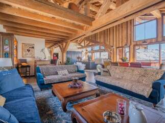 Luxurious chalet with stunning mountain views and exposed wooden beams.