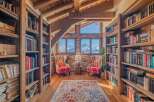 Cozy mountain chalet library with stunning views.