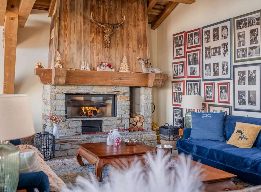 Cozy up by the fireplace in this stunning chalet, complete with a rustic stone hearth and wooden mantel.