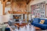 Cozy up by the fireplace in this stunning chalet, complete with a rustic stone hearth and wooden mantel.
