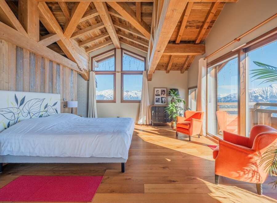 Luxurious chalet bedroom with stunning mountain views.