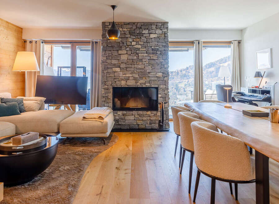 Experience luxury living in this stunning property, featuring a cozy fireplace and a spacious living area.